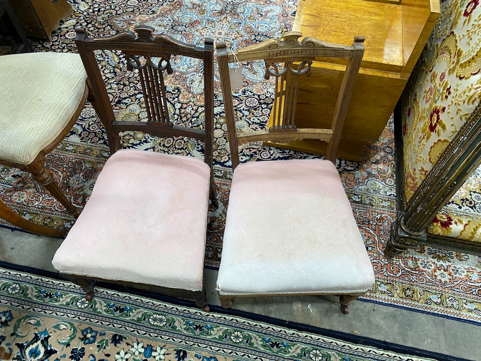 A pair of Victorian carved walnut balloon back dining chairs and a pair of late Victorian nursing chairs